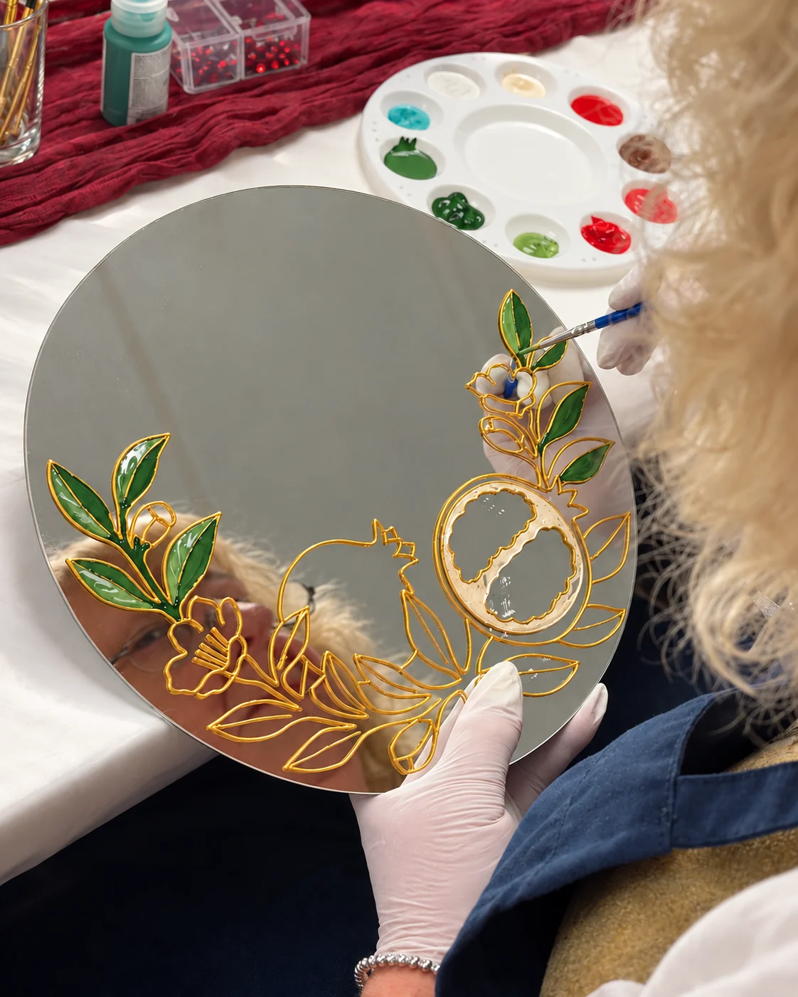 Painting green leaves inside the prepared gold outlines