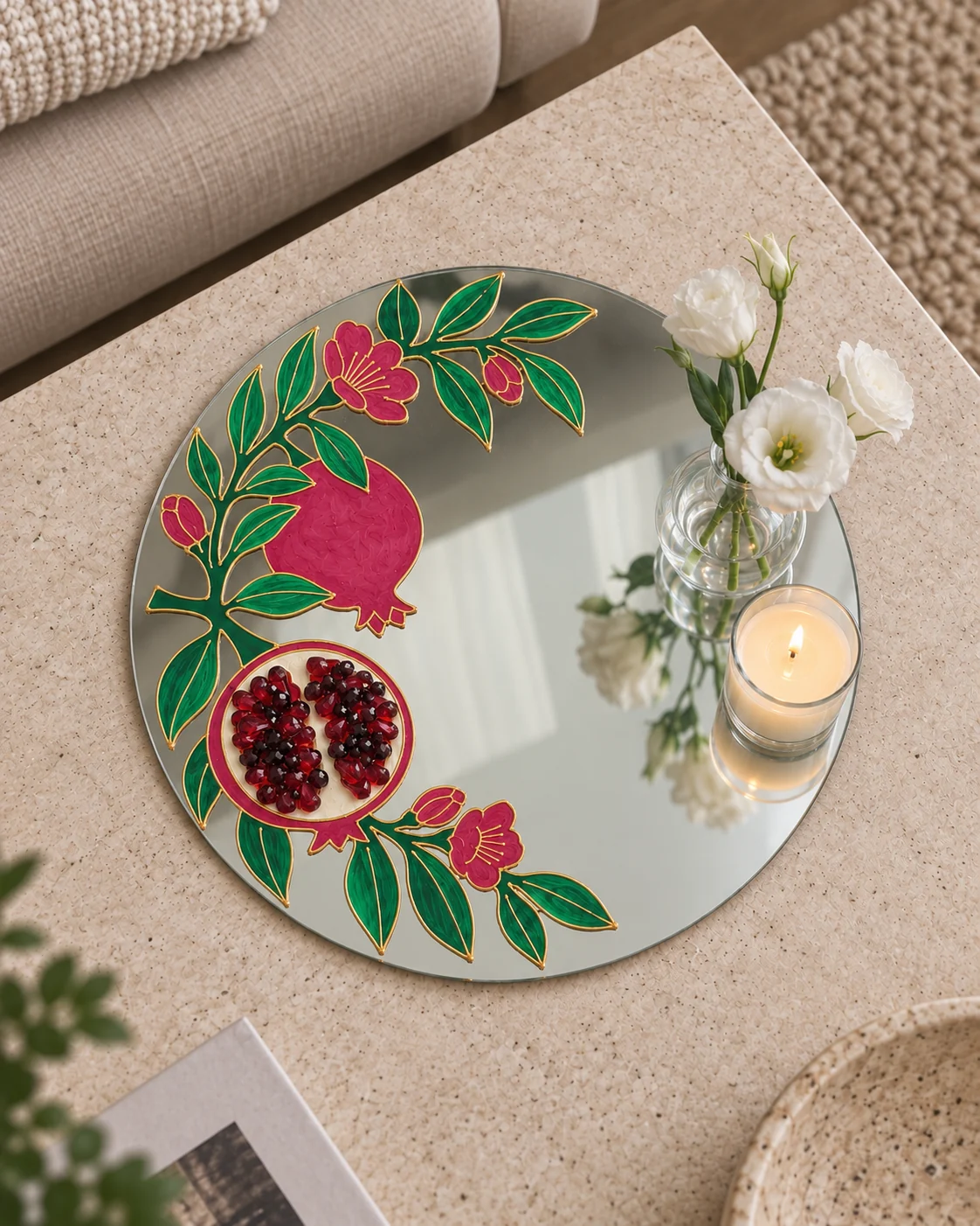 Pomegranate mirror with flowers and a candle in a glass holder